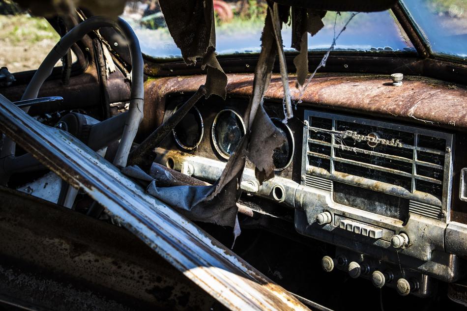 Rusty forgotten car on the street