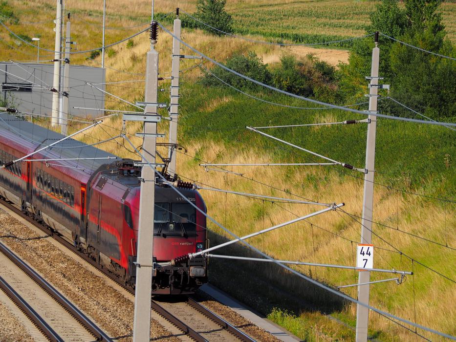 red train is going down the road