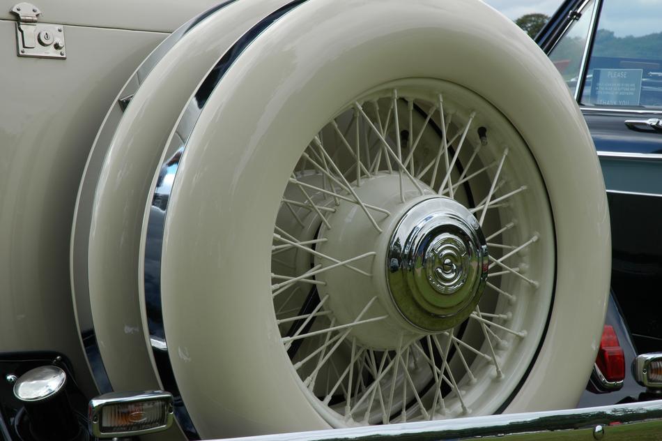 the white wheel of a classic car