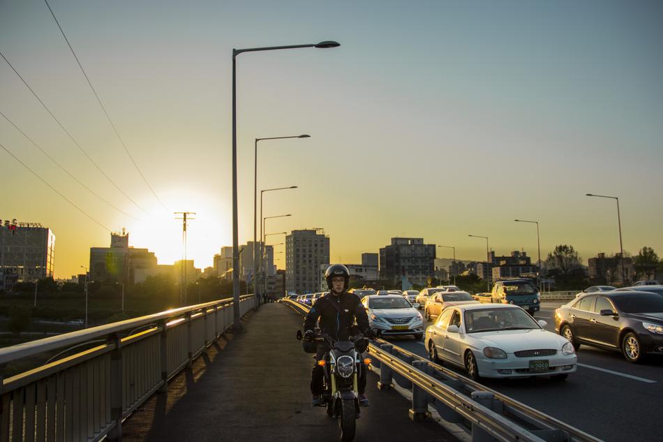 man on a motorcycle at sunset