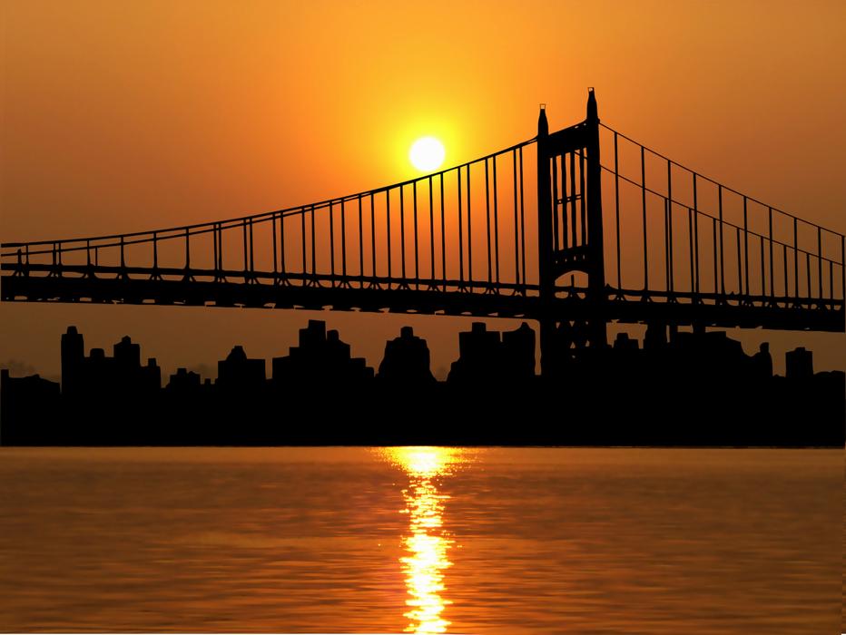 Brooklyn Bridge against the golden sky in New York