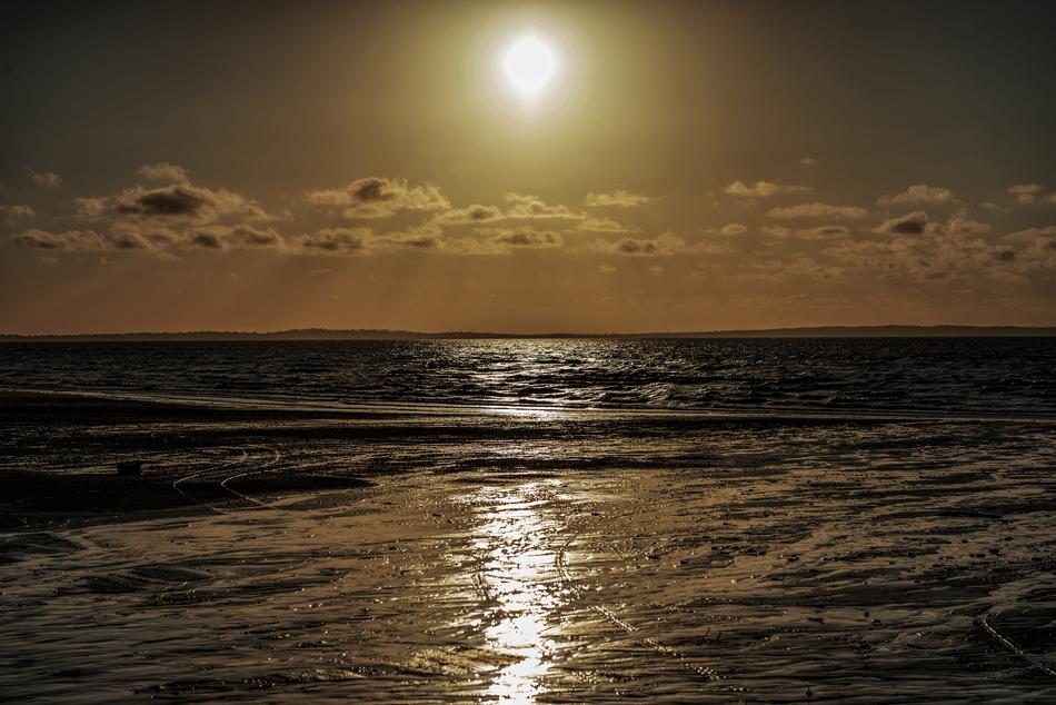 photo of the ocean against the evening sun