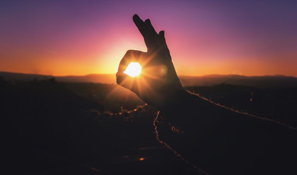 sun in hand at dusk