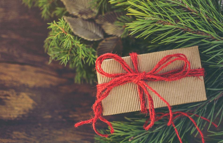gift with a red rope under the Christmas tree