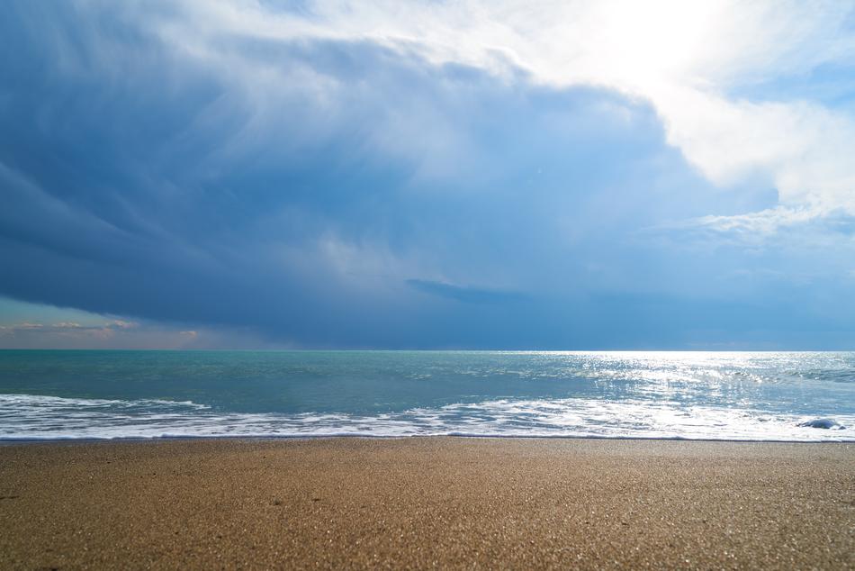 white clouds over the beach near the sea