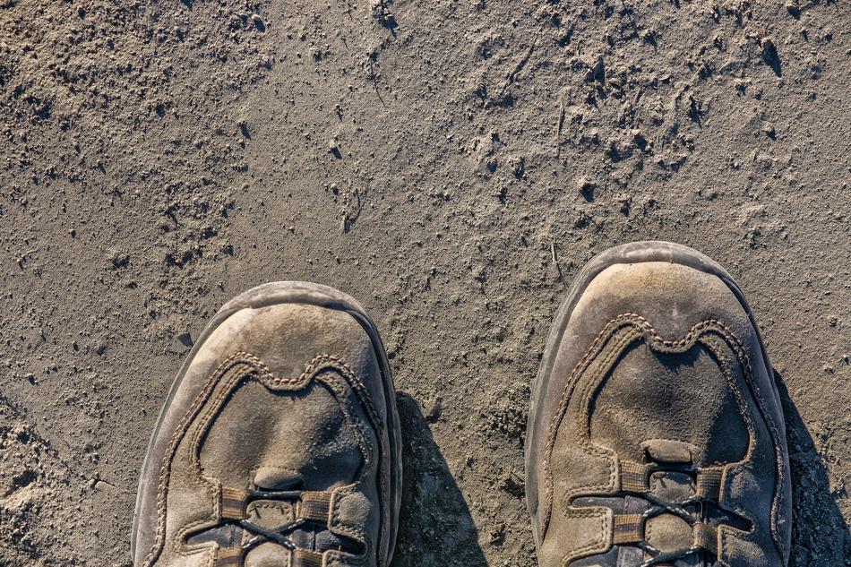 toes of Dusty Hiking Shoes on soil
