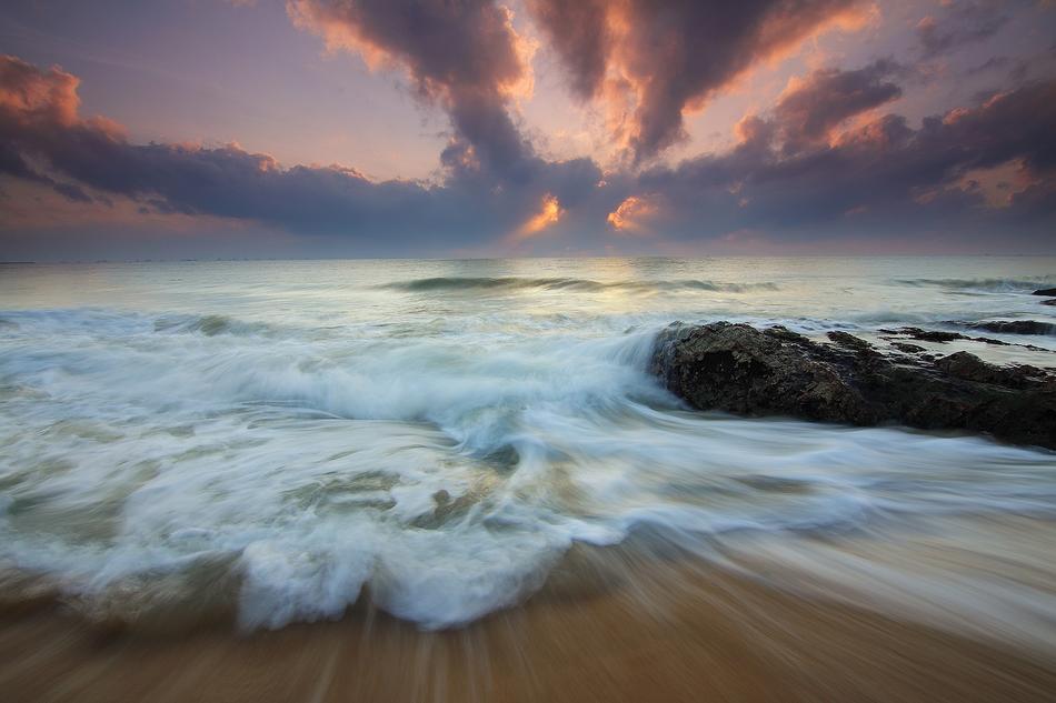 Motion of Waves on sand beach at sunrise