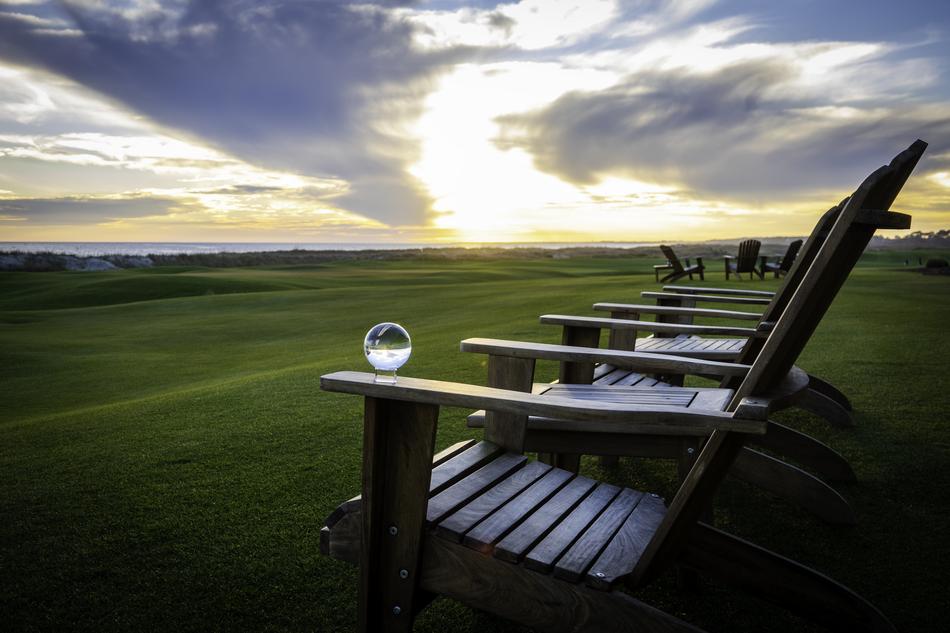 Crystal Ball on wooden chair in front of Golf Course at Sunset