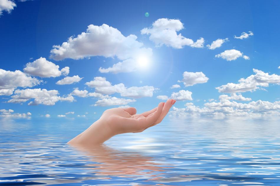 hand in the sea against the background of clouds