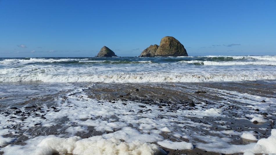 grey Rocks in blue sea near coast, usa, oregon, tillamook