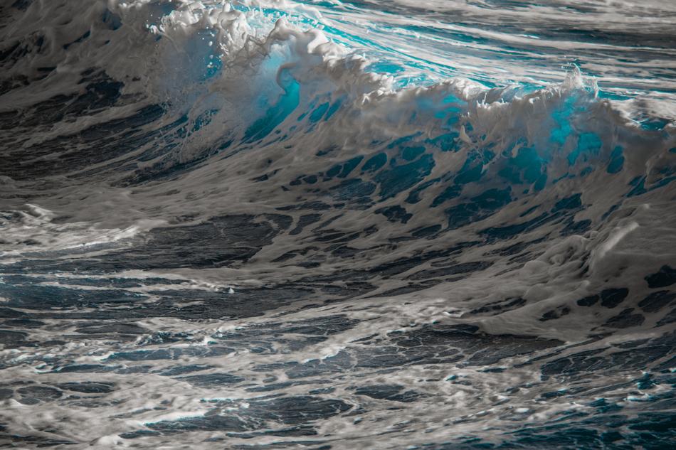 Close-up of the beautiful, turquoise water with the white waves, in the light and shadow