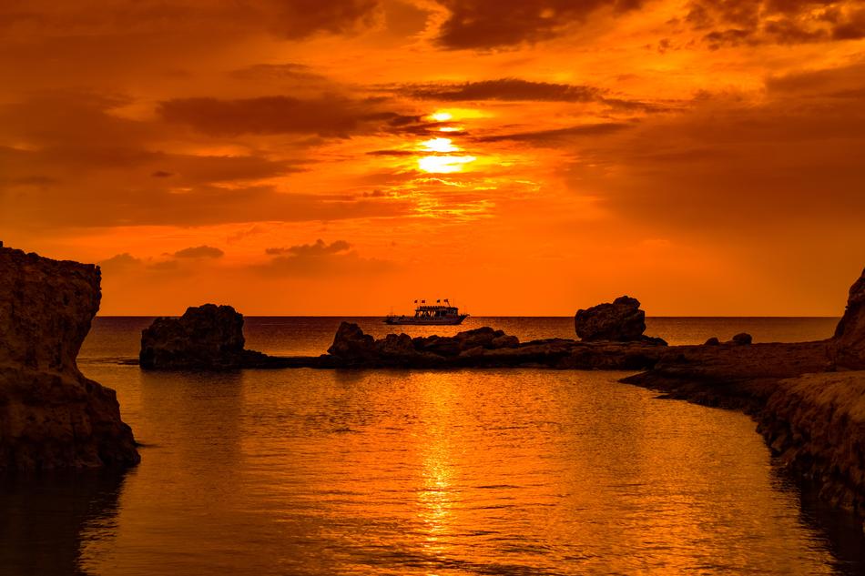 orange sunset on the rocky beach