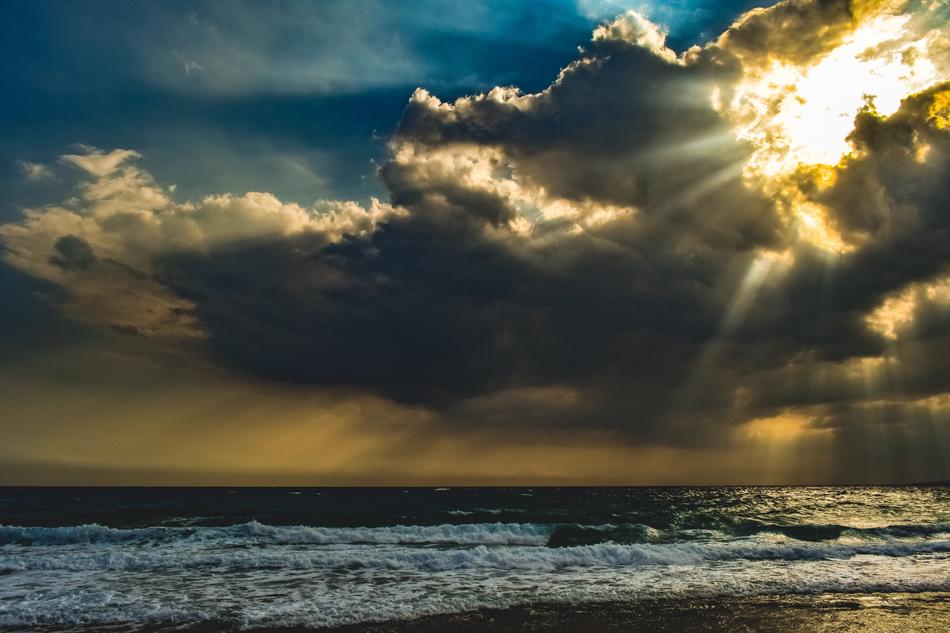 Beautiful and colorful sunlight through the clouds on the water