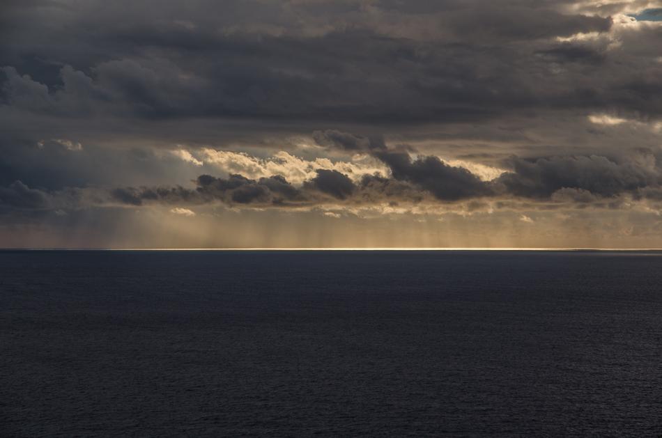 clouds over the calm sea at night