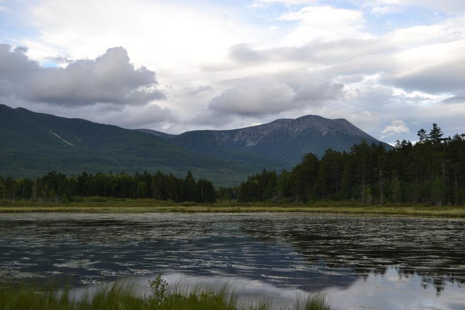 pond at the foot of the mountains on a cloudy day