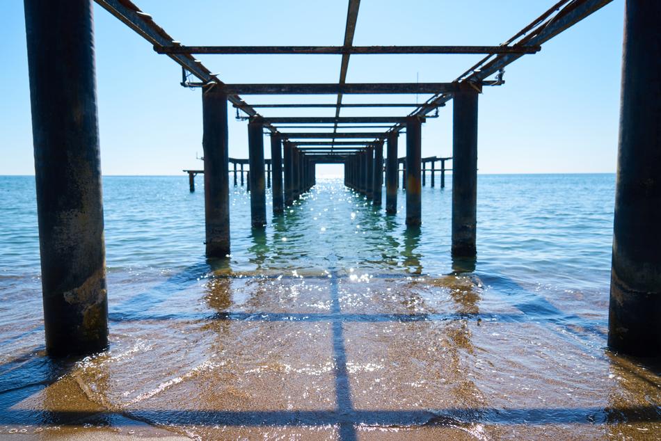 water under the old pier on a sunny day