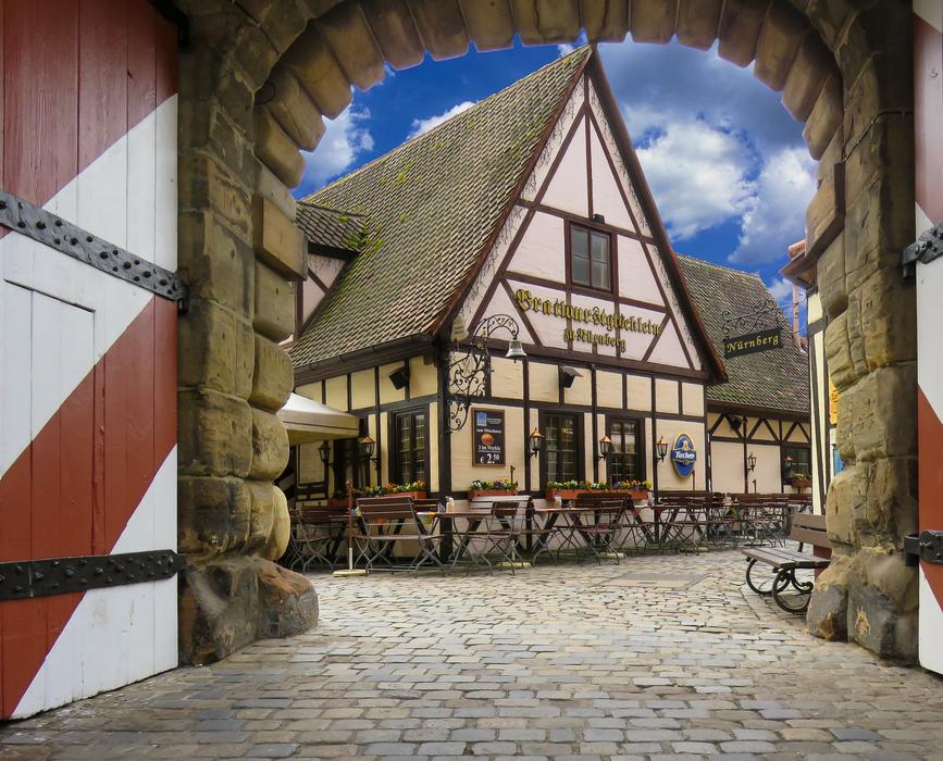 Beautiful and colorful architecture, with the Handwerkerhof in Nuremberg, Germany, under the blue sky with white clouds