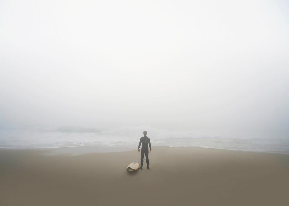 surfer on the coast in the fog