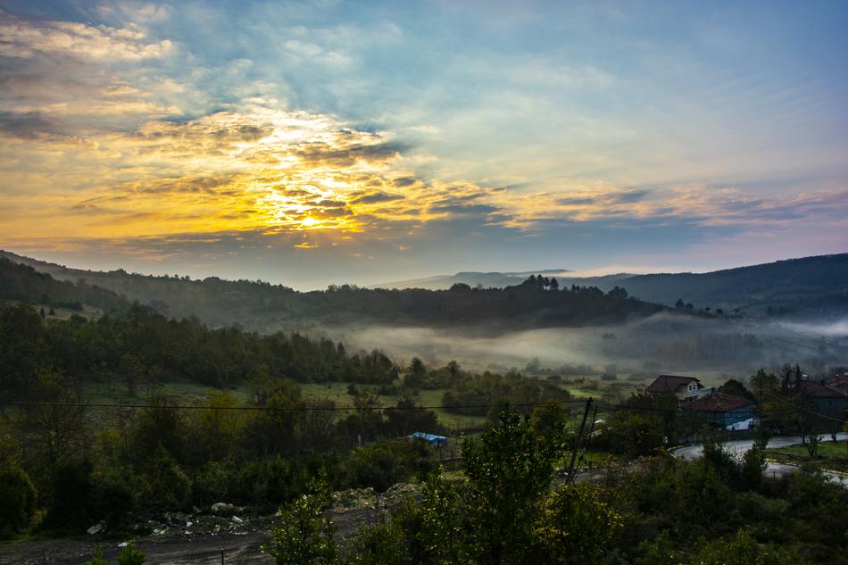 green sunset and fog over the plain