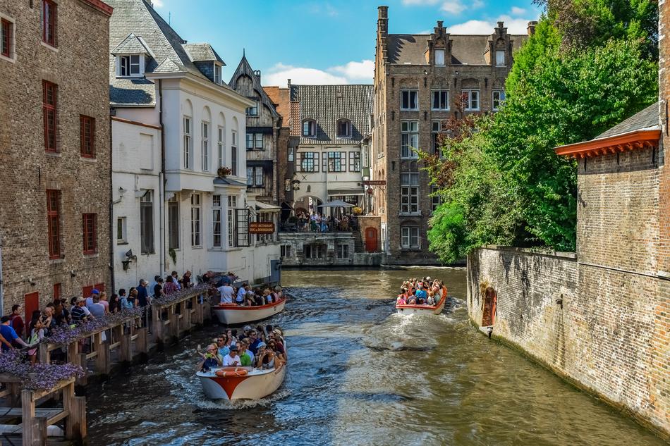 tourists on boats on the canal in Brugge