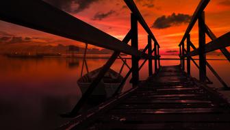 orange sunset over wooden pier