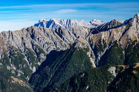 Beautiful landscape of the Alps, with the green plants, in Austria, at blue sky, with clouds on background
