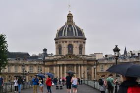 people near historical building on rainy weather, France, Paris