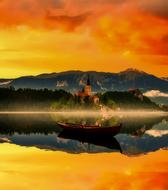 orange sky reflected in a picturesque lake in slovenia