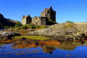 Beautiful and colorful landscape with the castle, on the shore of Loch Ness, in Scotland, at blue sky on background