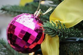 purple ball on christmas tree close-up on blurred background