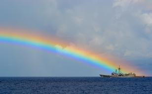 rainbow over a ship at sea