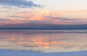 view from the frozen lake to the white volcano