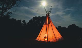 orange teepee at night