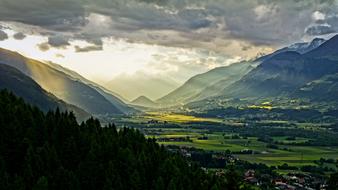 cloudy twilight over a village in a valley in austria