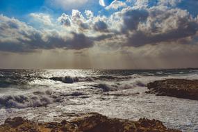 Beautiful landscape of the rocky beach of Ayia Napa, in Cyprus, Greece, in sunlight, under the blue sky with clouds