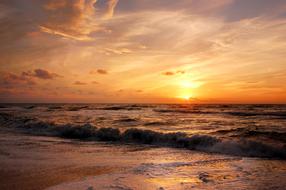 sun over the surf at dusk