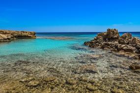 Beautiful rocky shore of Ayia Napa, Cyprus, Greece, with the turquoise water, at blue sky on background