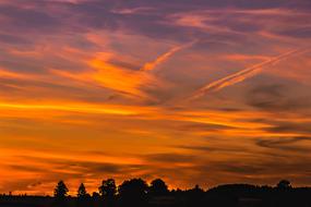 yellow sunset over dark silhouettes at dusk