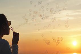 Sunset person soap bubbles