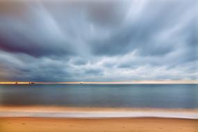cloudy dawn over a quiet surf