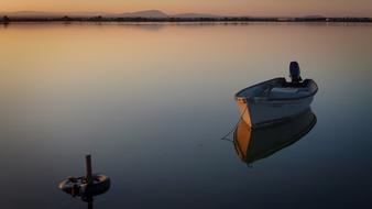 boat on calm water at dusk