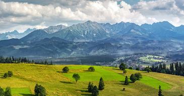 green fields near scenic Mountains