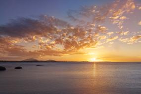 Yellow sunset over water on the horizon