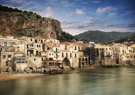 view from the water on the architecture of the sicilian coast