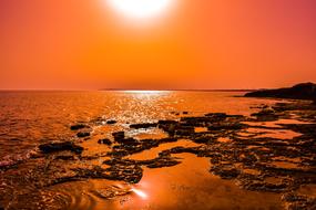 Beautiful landscape of the beach, near the water with the ripple, in Ayia Napa, Cyprus, Greece, at beautiful and colorful sunset