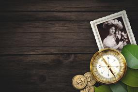 retro photo, compass and gold coins on the table