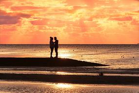 couple in love on the beach near the sea at dusk