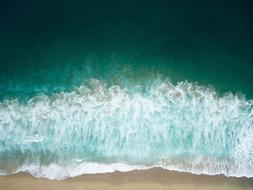 white foam on the waves on the beach