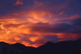 Beautiful landscape with the silhouettes of the hills, at beautiful and colorful sunset