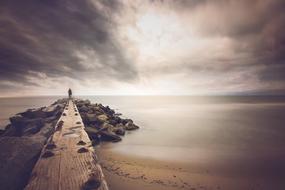 storm clouds over a pier in the ocean